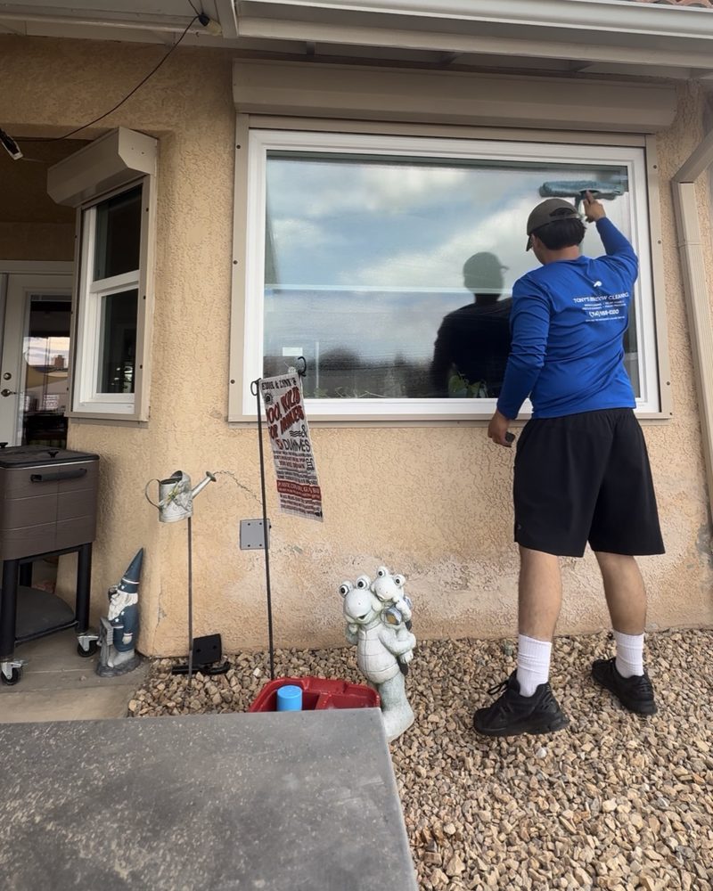 Tony squeegeeing a large picture window at a Hesperia home