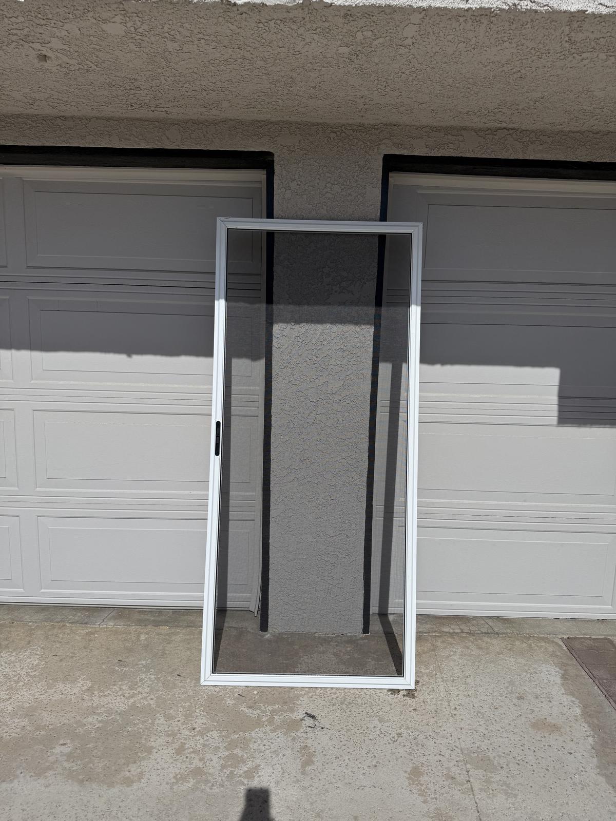 Sliding door screen with fresh mesh after on-site re-meshing