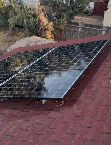 Solar array on a shingle roof in Adelanto with mesh clipped around it
