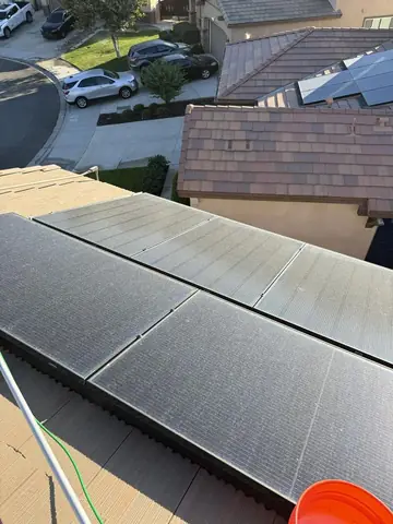 Solar panels in Hesperia partway through a water fed pole wash