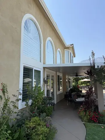 Tall arched windows on a two story home, clean after a visit