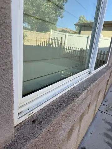 Clean slider glass and sill on a Victorville home